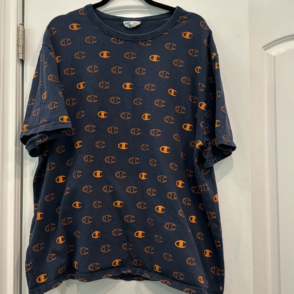 Champion t-shirt. Navy covered in orange “C” Champion logos. XXL